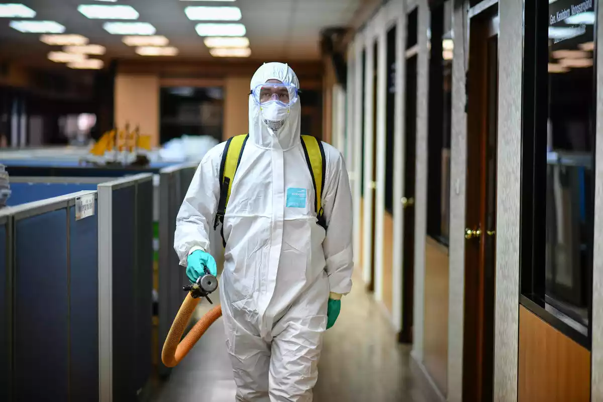 Un treballador de Tailàndia desinfectant una sala de reunions el 10 de març de 2020