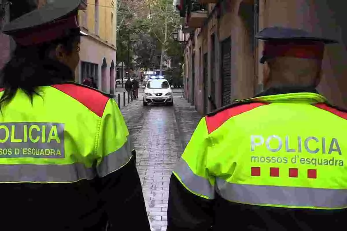 Pla mitjà de dos agents dels Mossos d'Esquadra d'esquena patrullant per Ciutat Vella, publicada el 23 de novembre de 2018