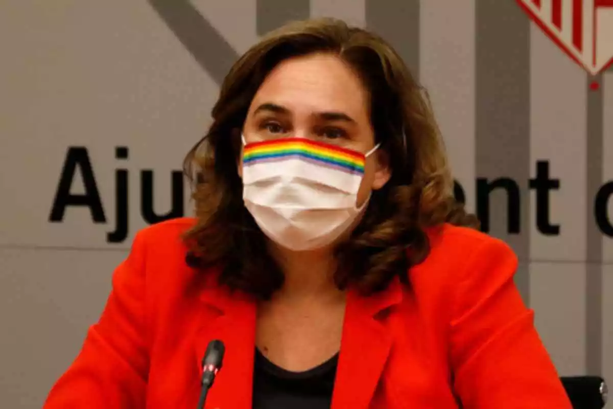 L'alcaldessa de Barcelona, Ada Colau, amb una jaqueta vermella i mascareta amb els colors LGTBI
