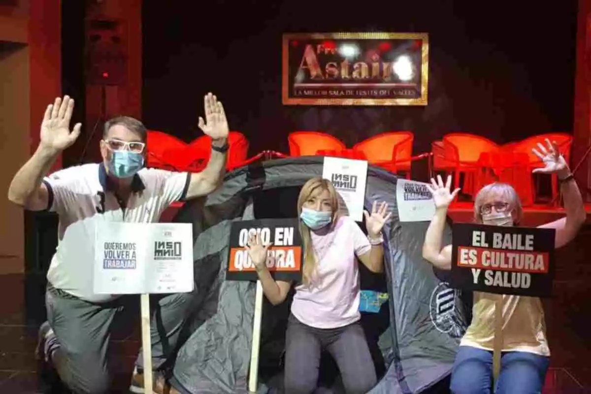 Imatge dels responsables de la Sala Fred Astaire de Terrassa durant el tancament, amb cartells de protesta i una tenda de campanya per passar la nit