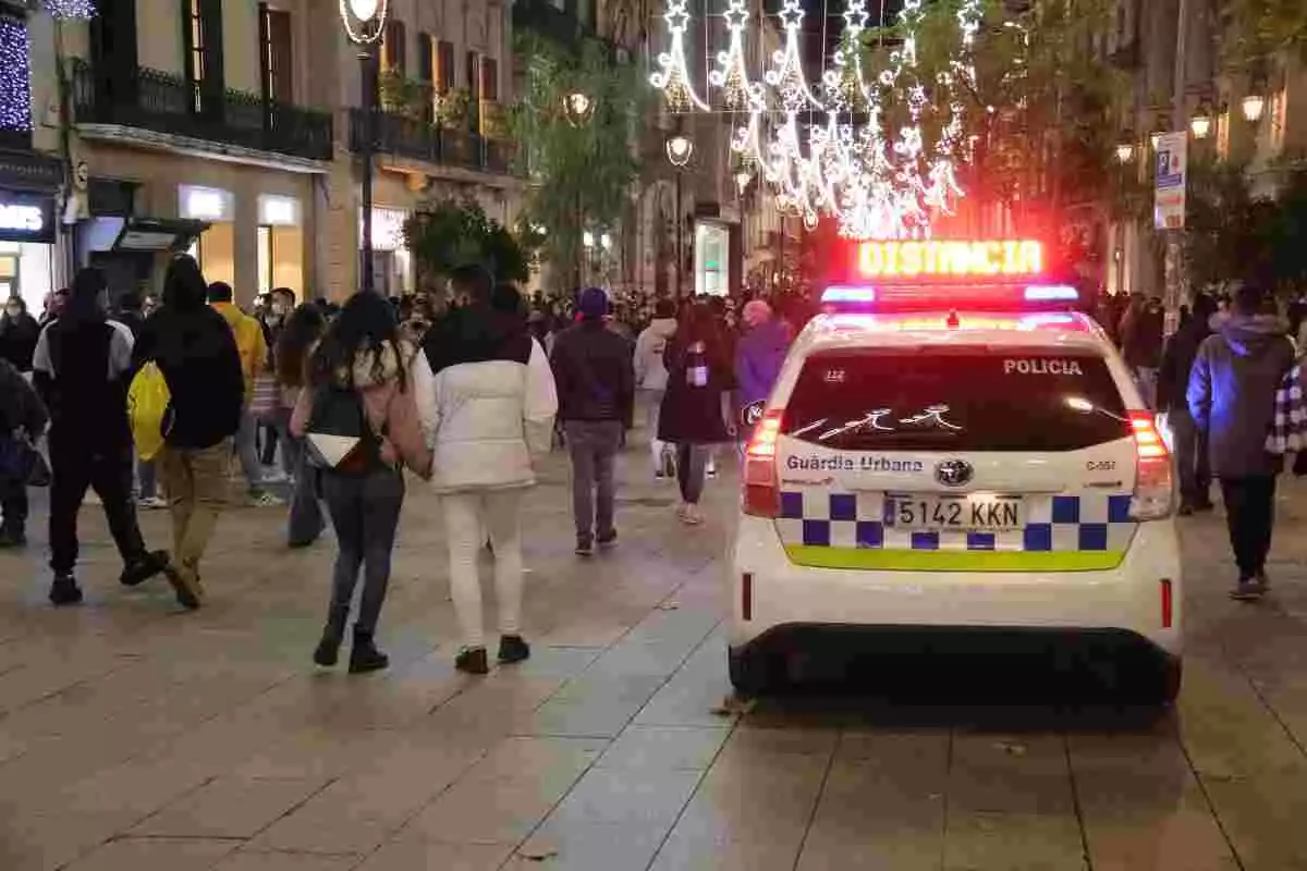 Un cotxe de la Guàrdia Urbana de Barcelona demanant distància social al Portal de l'Àngel de Barcelona