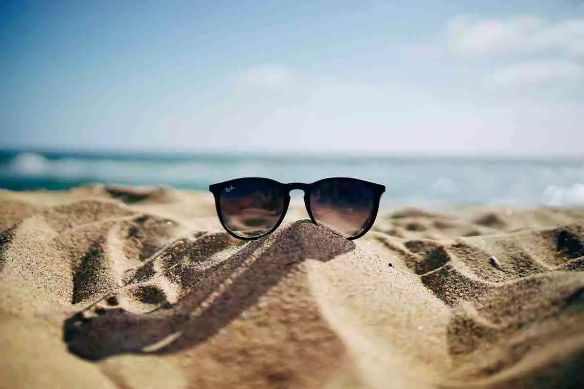 Unes ulleres de sol situades a la sorra d'una platja