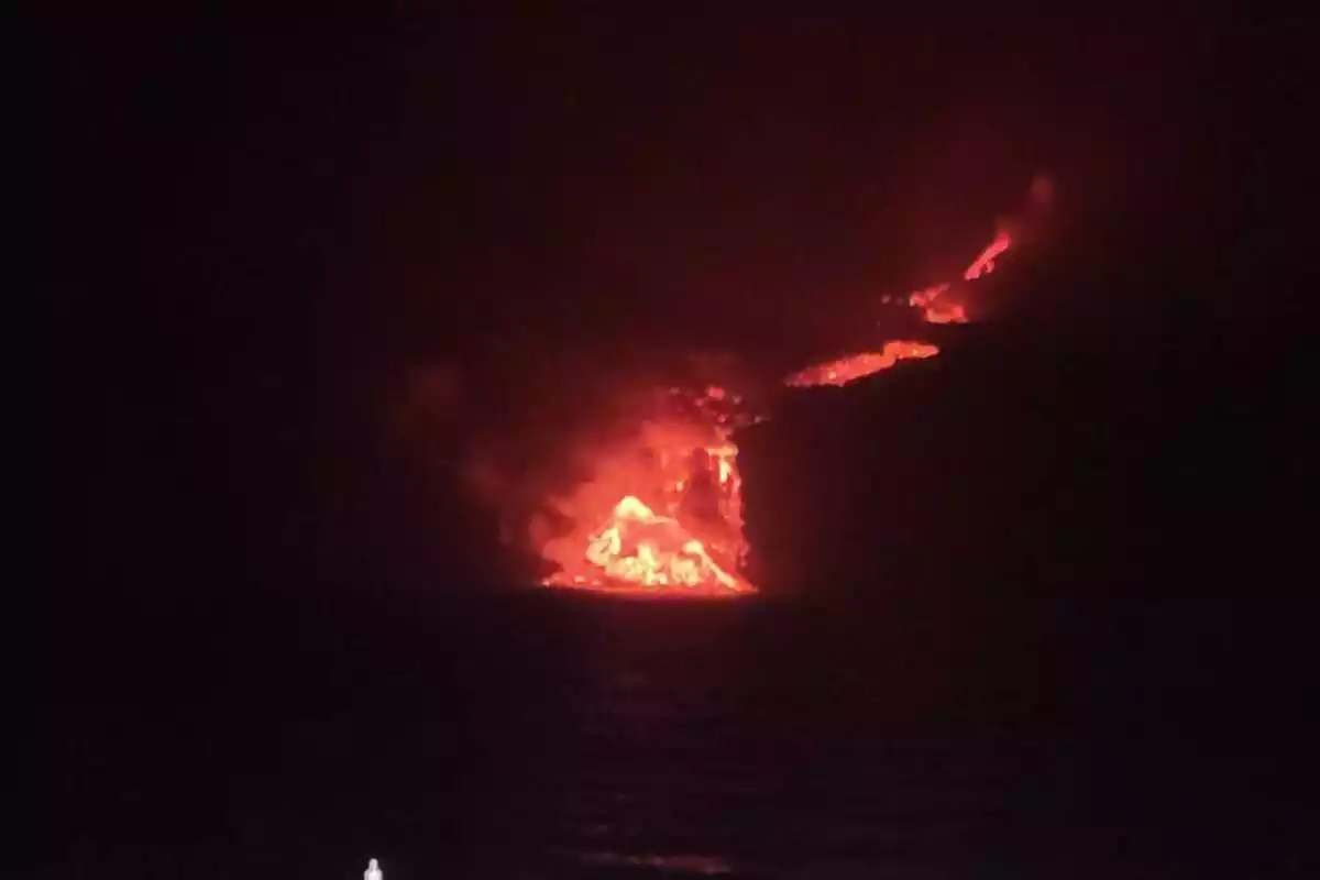 Imatge de la lava del volcà Cumbre Vieja arribant a la mar durant la nit