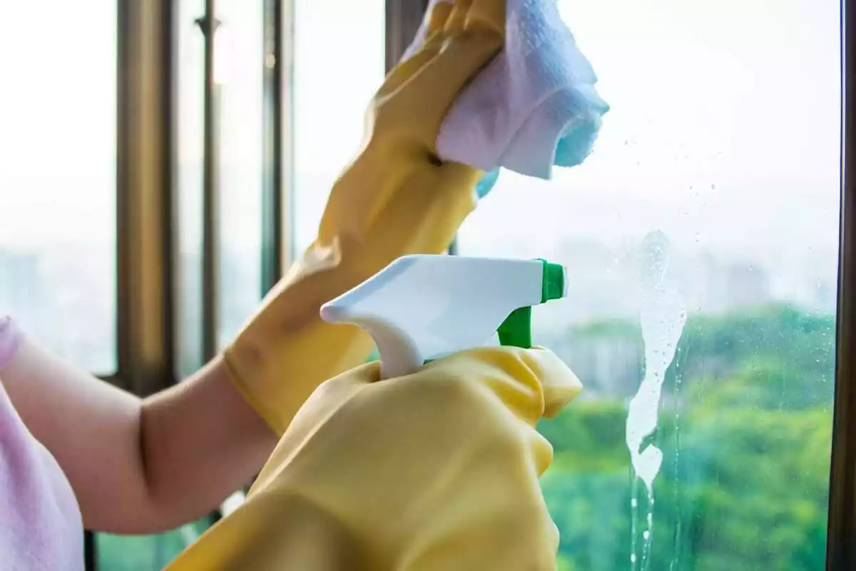 Foto d'una persona netejant un vidre.