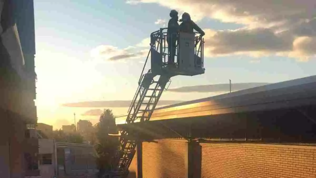 Imatge dels Bombers assegurant el sostre del pavelló del Serrallo, afectat pel vent