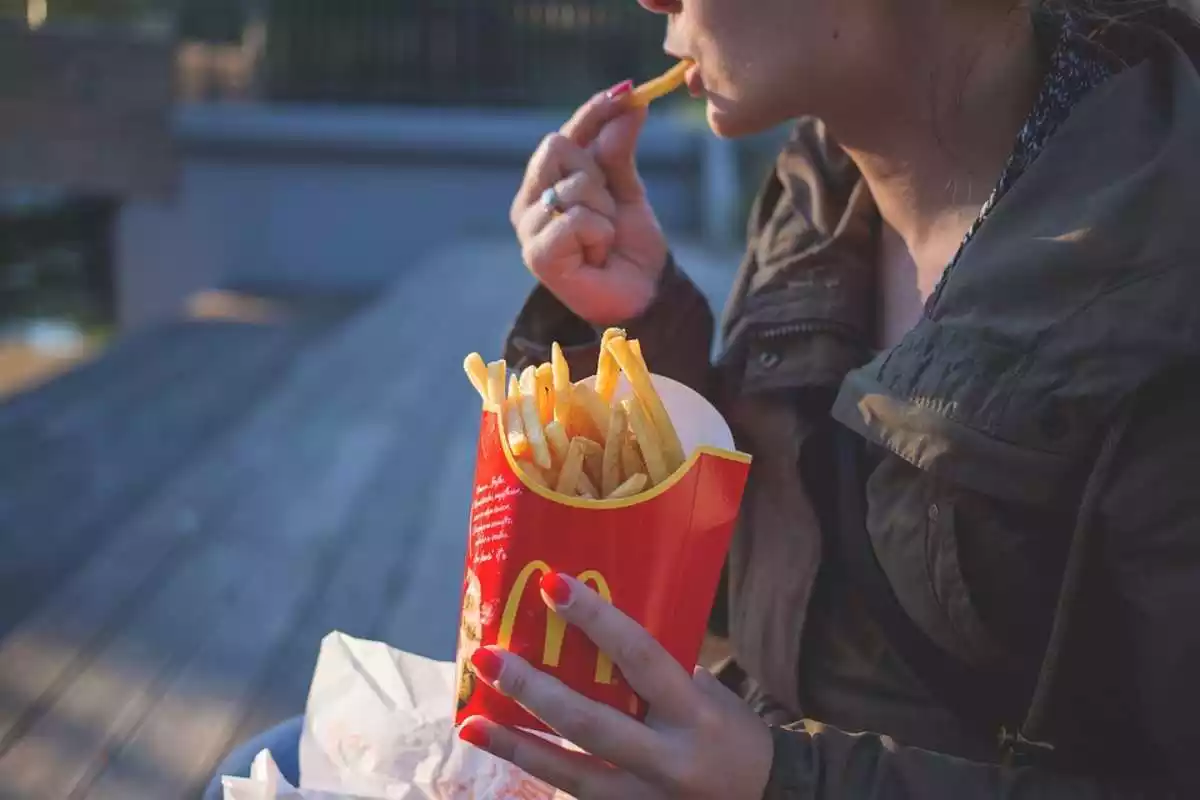 Imatge d'una persona menjant patates del McDonald's