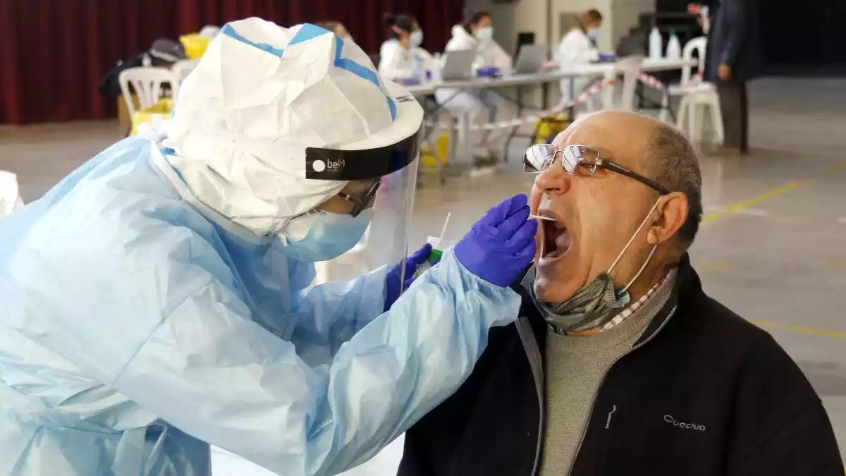 Pla tancat d'un home fent-se la prova PCR amb un tècnic sanitari al pavelló de l'Oli de les Borges Blanques