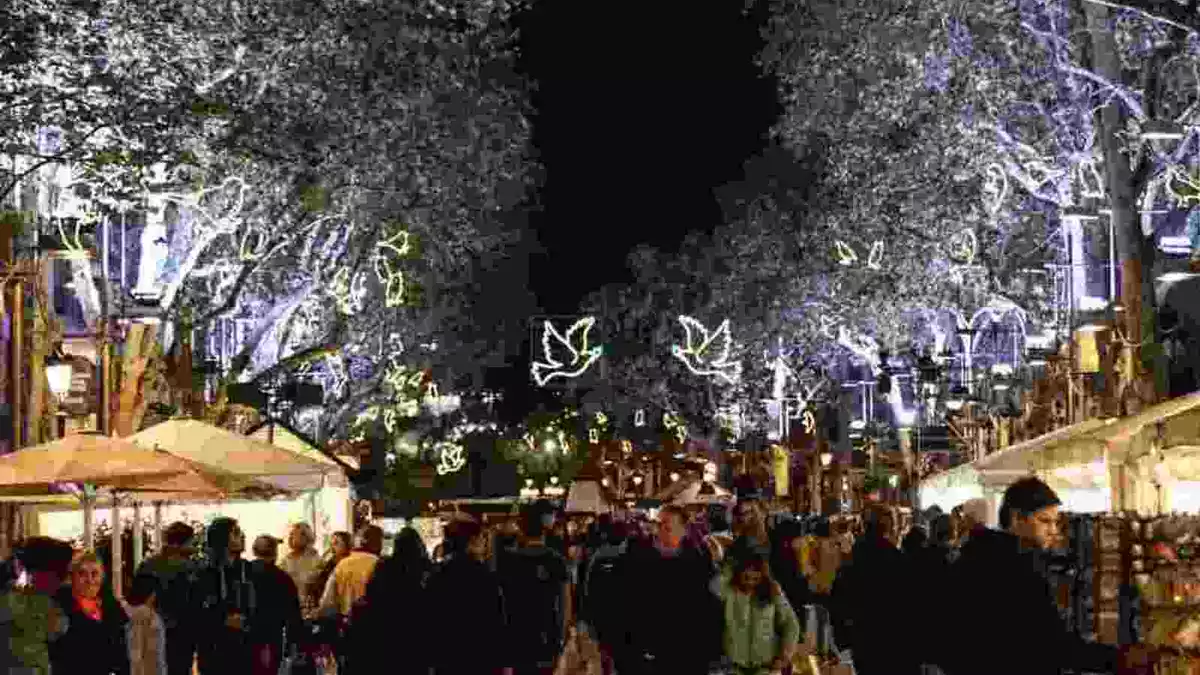 Imatge de gent passejant per la Rambla decorada per Nadal