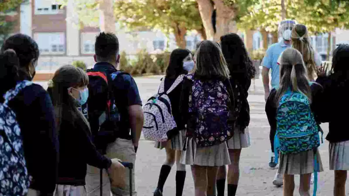 Un grup de nens entrant a l'escola amb mascaretes