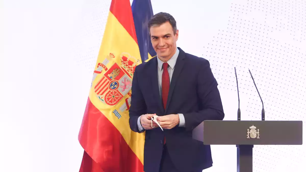 El president espanyol Pedro Sánchez amb una bandera nacional i una altra de la UE darrere