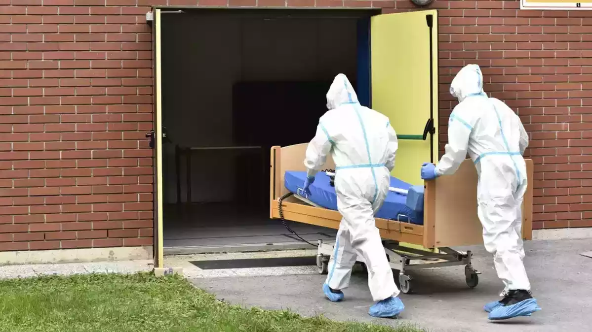 Imatge de dos sanitaris transportant un cadàver