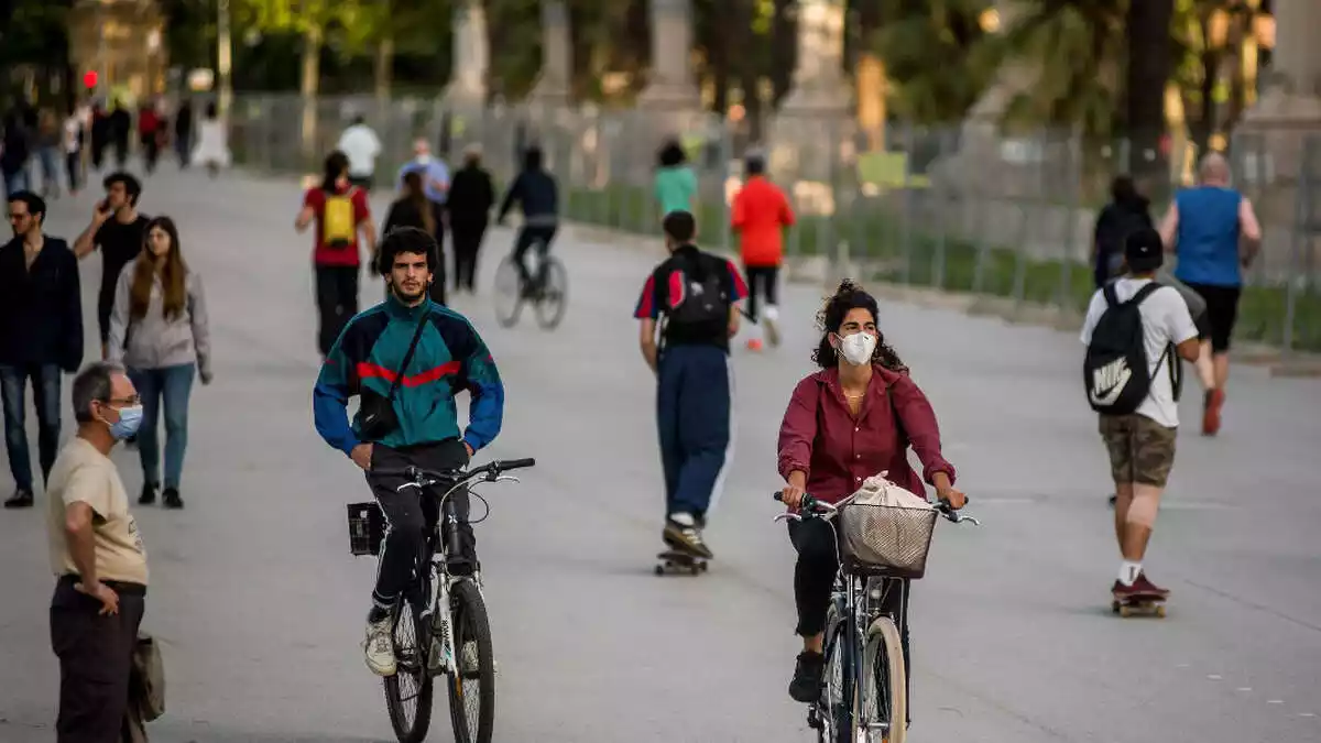 People walking or riding a bike in masks