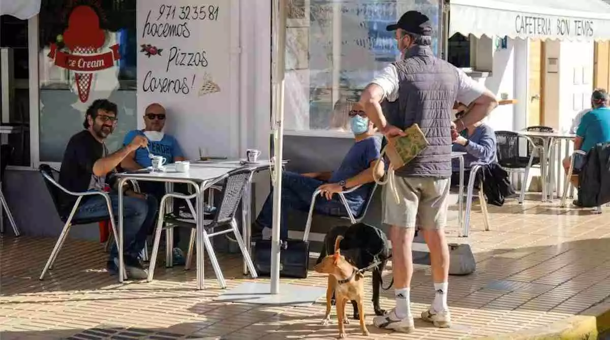 Un grupo de amigos desayuna en una cafetería abierta en Formentera este lunes.