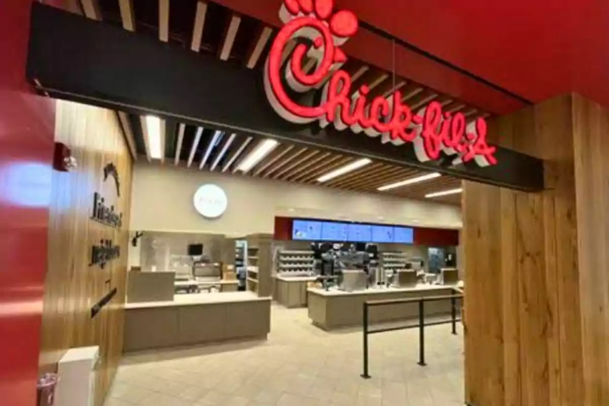 Entrance of a Chick-fil-A restaurant with counters and a digital menu in the background Entrance of a Chick-fil-A restaurant with counters and a digital menu in the background