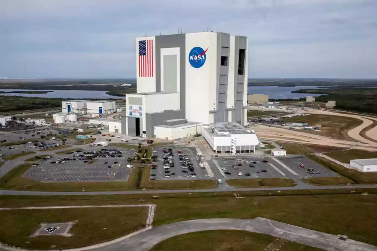 NASA Vehicle Assembly Building at the Kennedy Space Center surrounded by parking lots and green areas NASA Vehicle Assembly Building at the Kennedy Space Center surrounded by parking lots and green areas