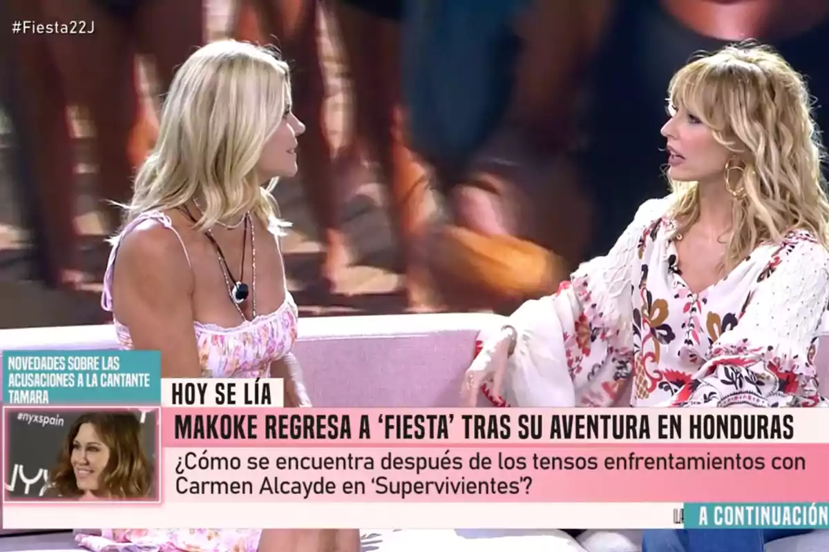Makoke i Emma García conversen assegudes en un plató de televisió amb un rètol que anuncia el retorn de Makoke al programa Festa després de la seva aventura a Hondures. Captura de 'Festa' Makoke i Emma García conversen assegudes en un plató de televisió amb un rètol que anuncia el retorn de Makoke al programa Festa després de la seva aventura a Hondures. Captura de 'Festa'