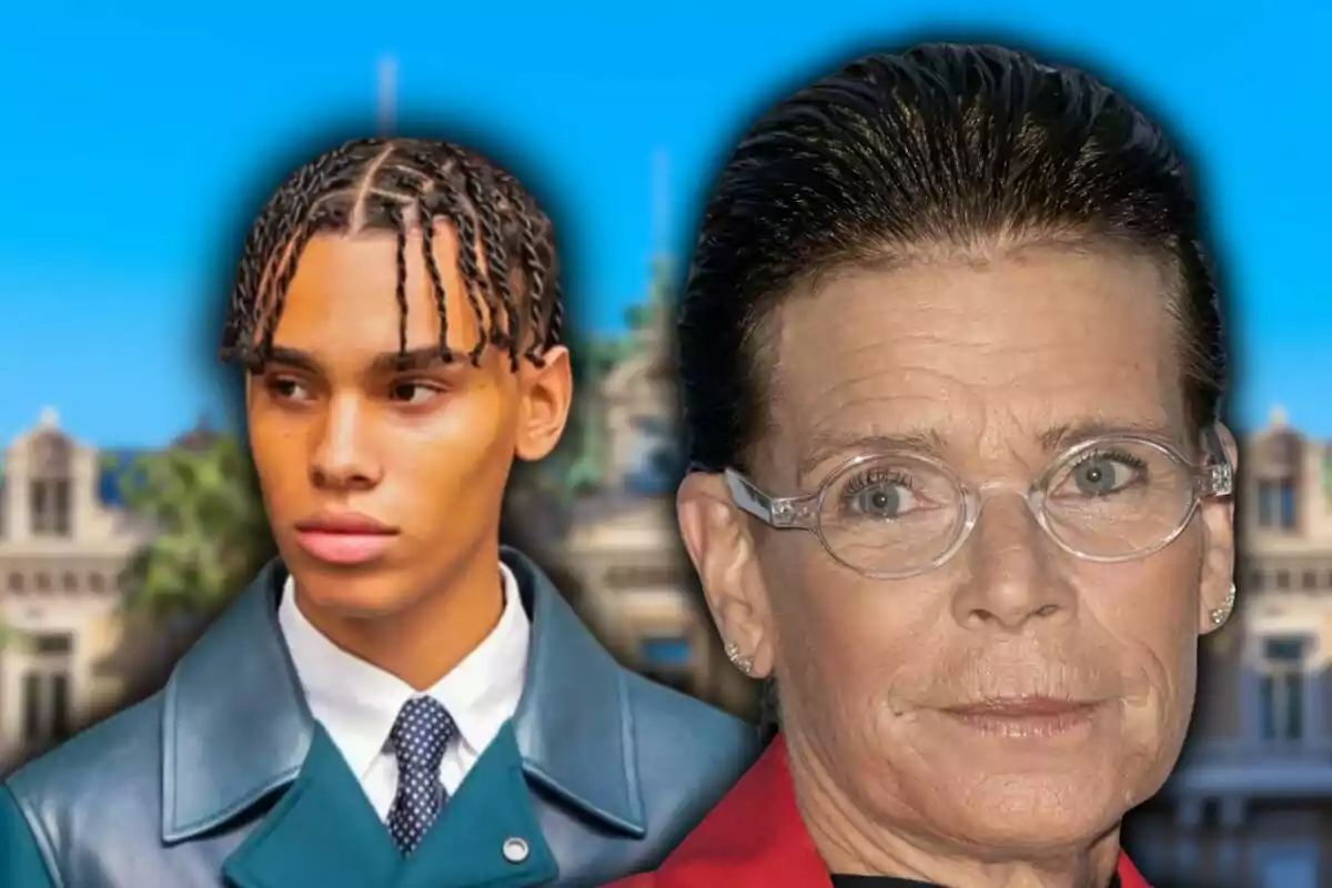 A young man with braids and a blue coat next to an older woman with glasses and her hair pulled back, both in front of a building and blue sky background