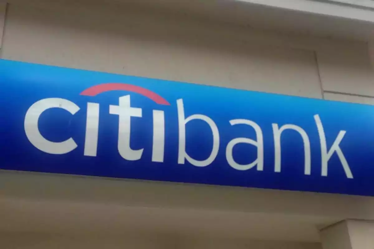 Blue sign with the Citibank logo in white letters and a red arc. Blue sign with the Citibank logo in white letters and a red arc.