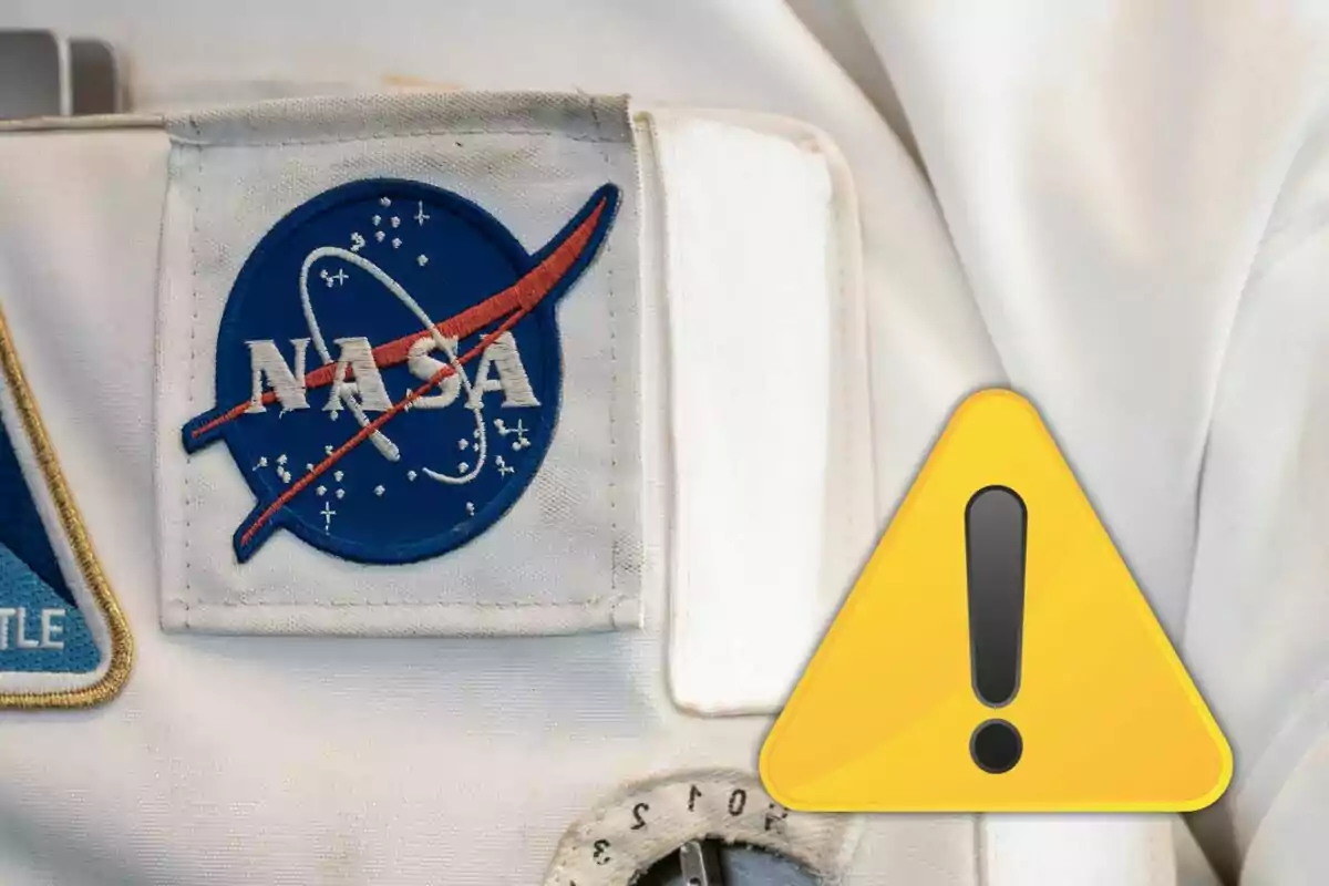 White uniform with the NASA logo and a yellow warning symbol with an exclamation mark