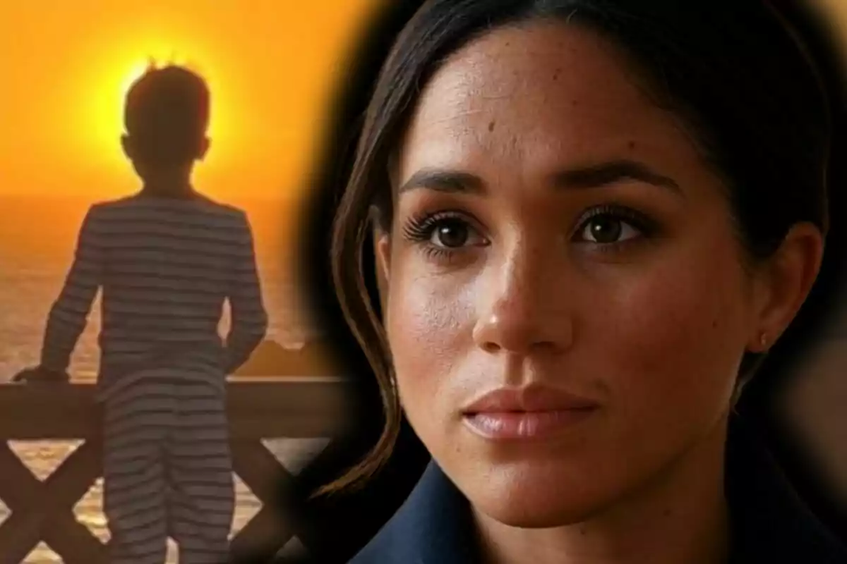 Close-up of Meghan Markle looking serious and facing forward, while in the background the silhouette of a child—her son Archie—is seen from behind, watching the sunset by the sea.