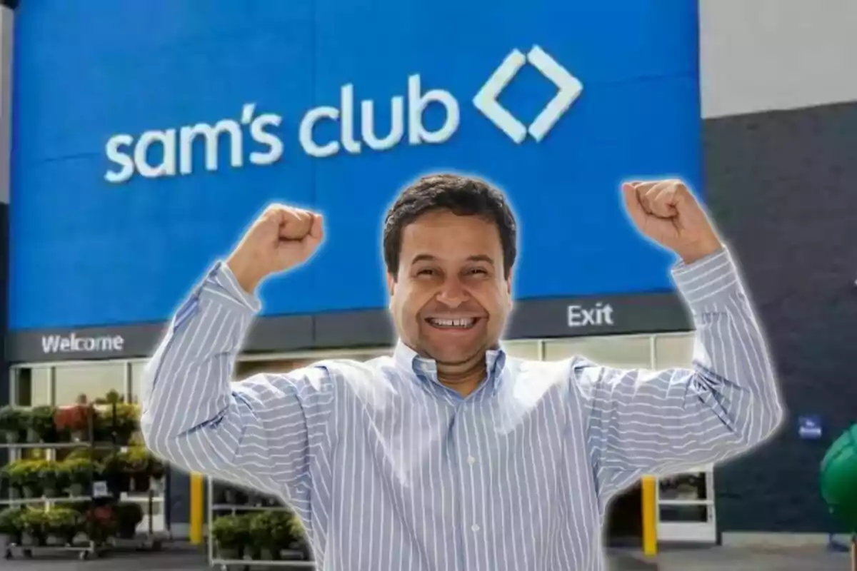 Smiling man with his arms raised in front of a Sam's Club store entrance