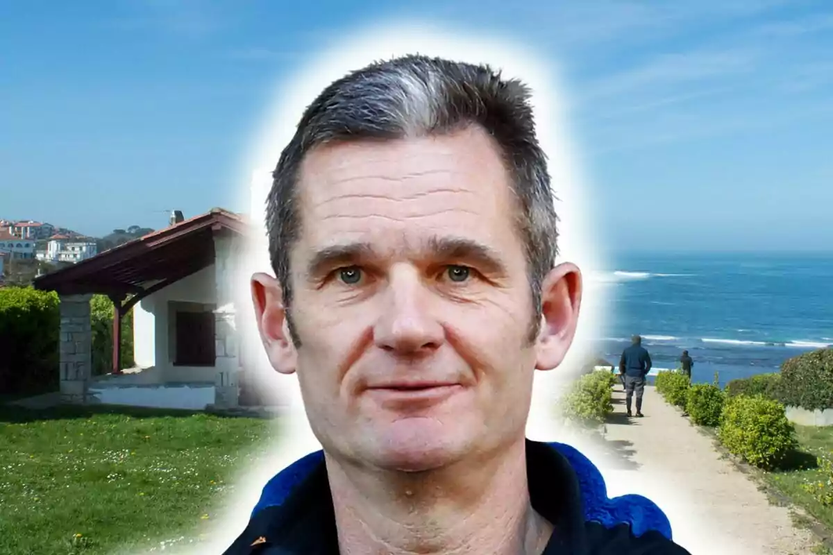 Close-up of Iñaki Urdangarin, and in the background, a small house and a path by the sea on a sunny day in Bidart.