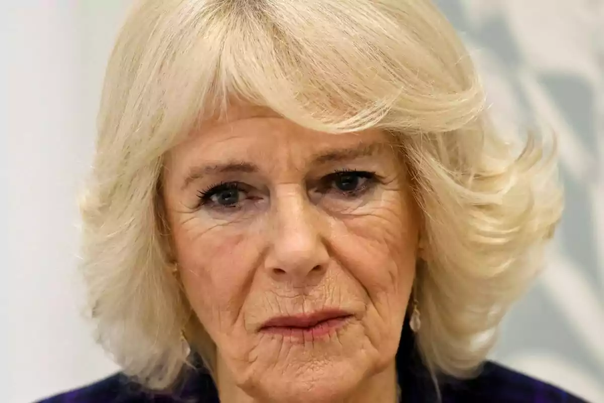 Close-up of Queen Camilla with a serious expression looking straight ahead.