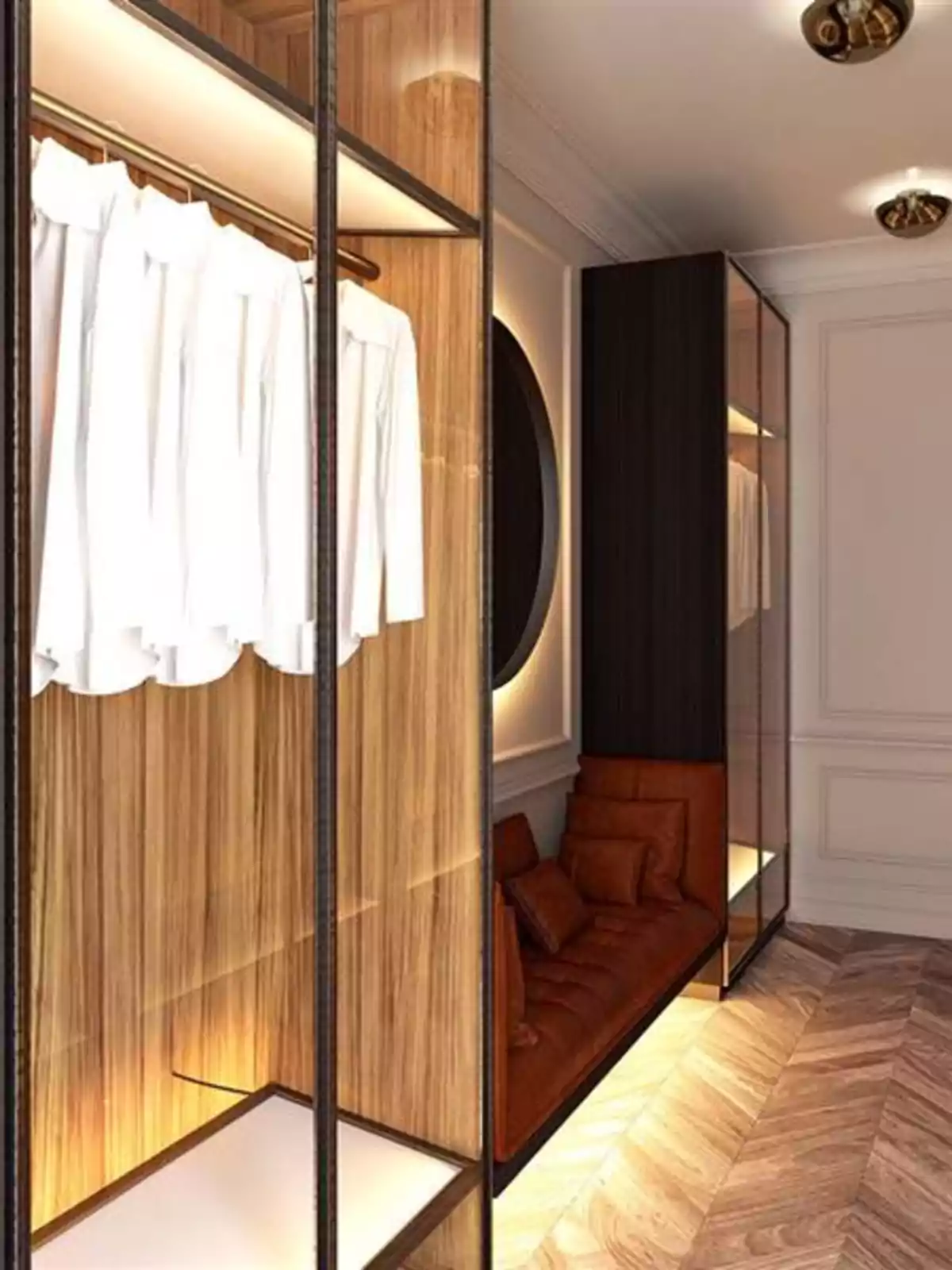 Vestidor modern amb armaris de fusta, camises blanques penjades i un sofà marró al costat d’una paret clara amb motllures. Vestidor modern amb armaris de fusta, camises blanques penjades i un sofà marró al costat d’una paret clara amb motllures.