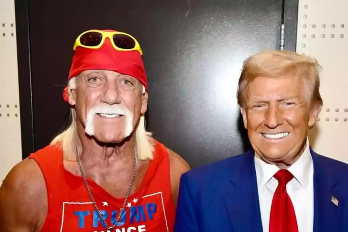 Two men smile posing together, one is wearing a red tank top and a bandana with sunglasses, the other is dressed in a blue suit with a red tie. Two men smile posing together, one is wearing a red tank top and a bandana with sunglasses, the other is dressed in a blue suit with a red tie.
