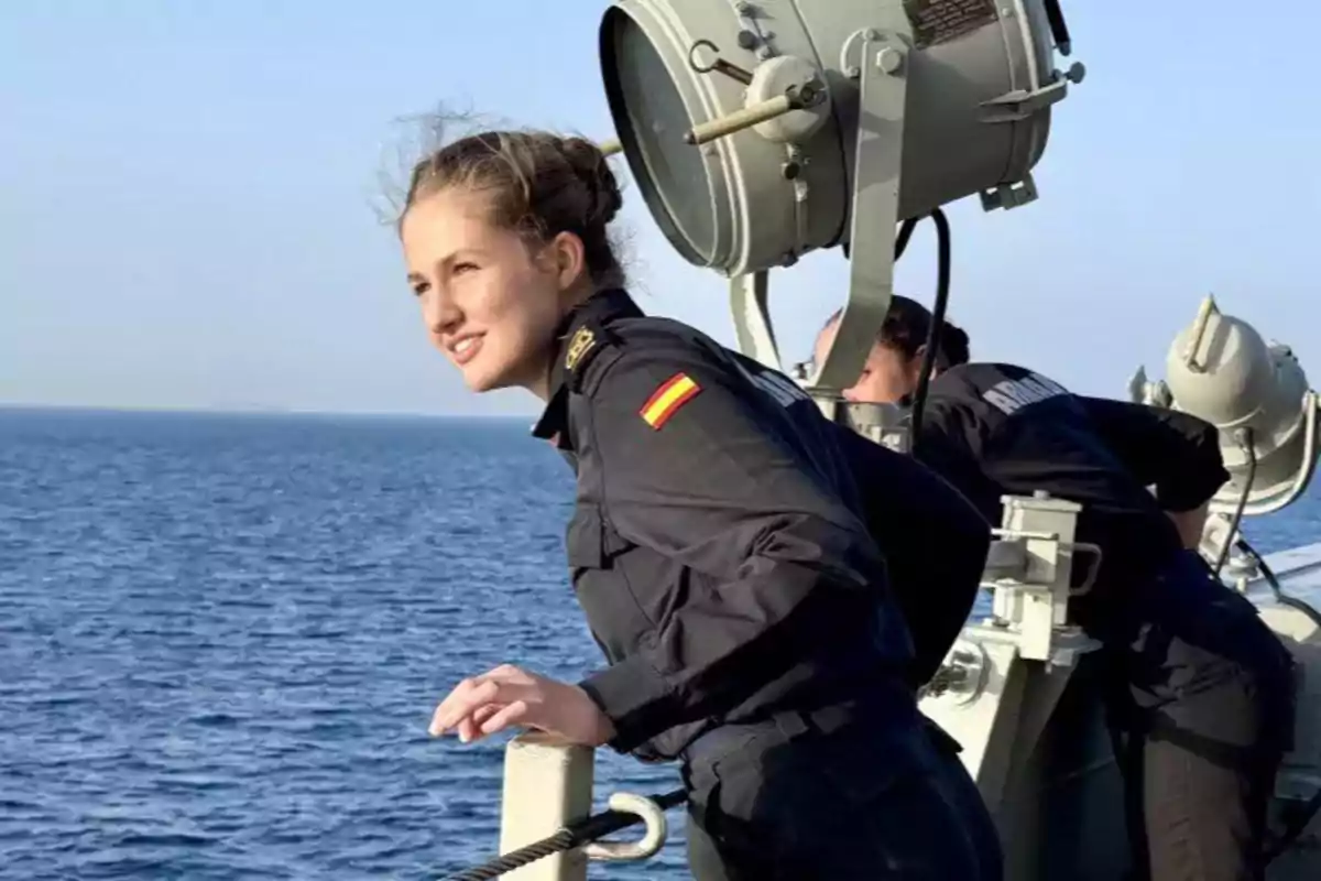Young man in Spanish Navy uniform watching the sea from the deck of a ship Young man in Spanish Navy uniform watching the sea from the deck of a ship