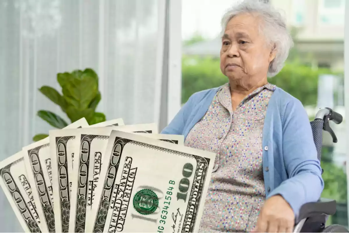 Elderly woman sitting in a wheelchair with several hundred-dollar bills in the foreground Elderly woman sitting in a wheelchair with several hundred-dollar bills in the foreground