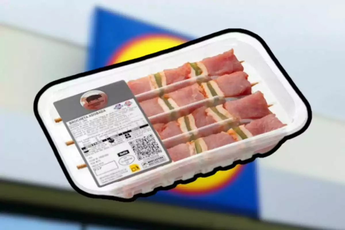 Safata de broquetes adobades envasades davant d’un cartell borros de supermercat Safata de broquetes adobades envasades davant d’un cartell borros de supermercat
