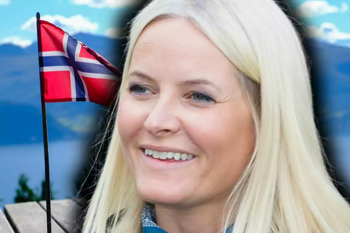 Mette-Marit amb una bandera de Noruega i un paisatge de muntanyes al fons.