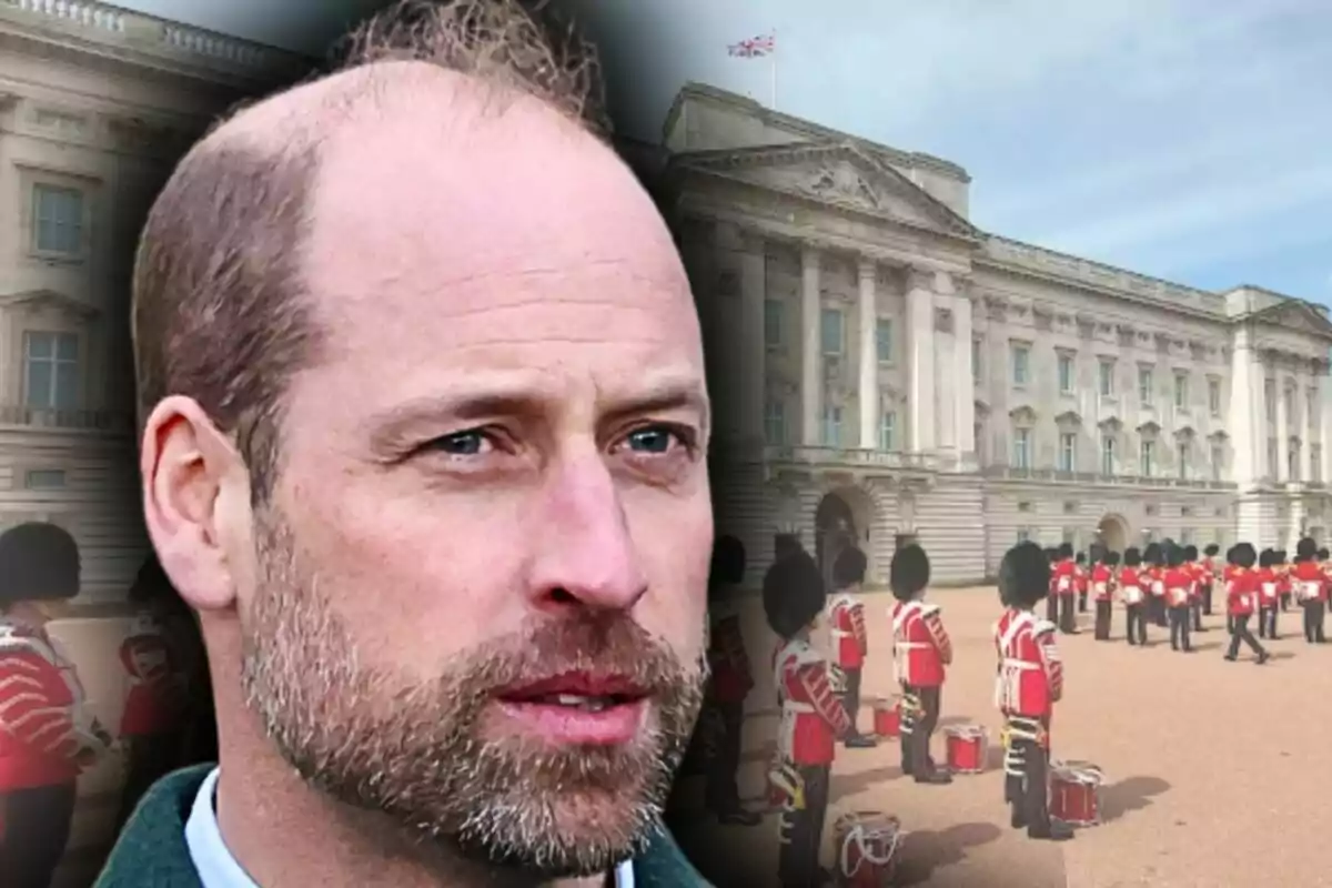 Close-up of Prince William with the blurred background of Buckingham Palace and uniformed British guards.