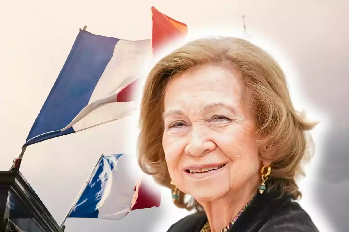 Queen Sofía smiling in the foreground with French flags waving in the background.