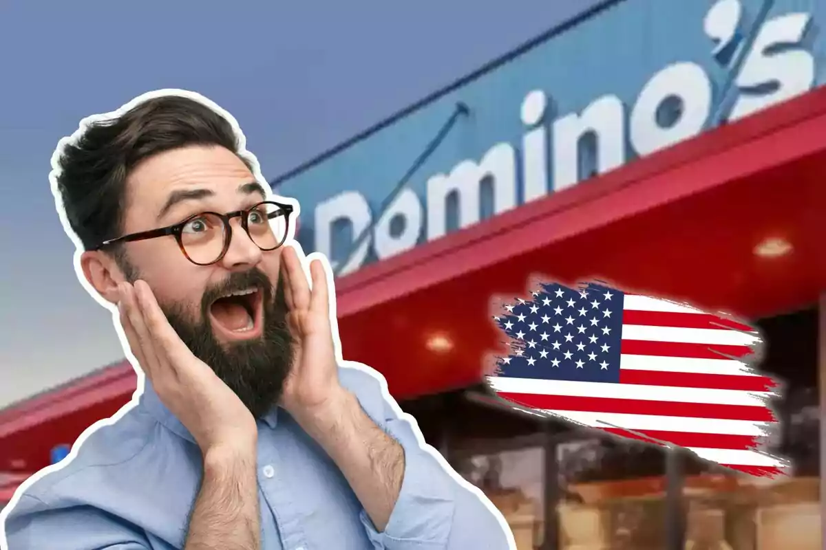 Man with a surprised expression in front of a Domino's Pizza branch with a United States flag next to it.