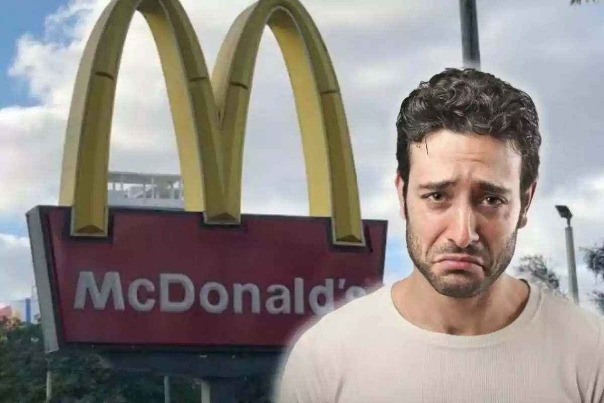 Man with a sad expression in front of a McDonald's sign