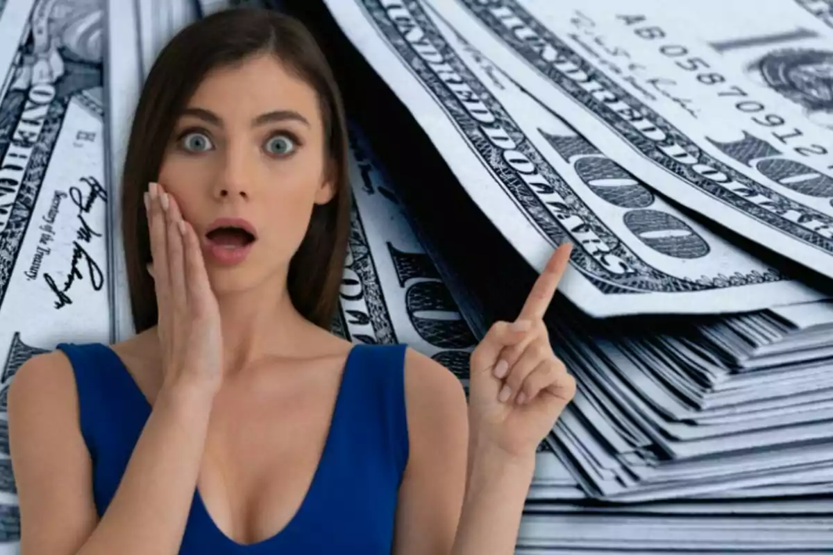 Surprised woman pointing at a large stack of hundred-dollar bills