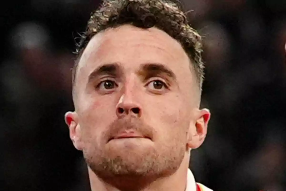 Close-up of Diogo Jota with a serious expression and a blurred background. Close-up of Diogo Jota with a serious expression and a blurred background.