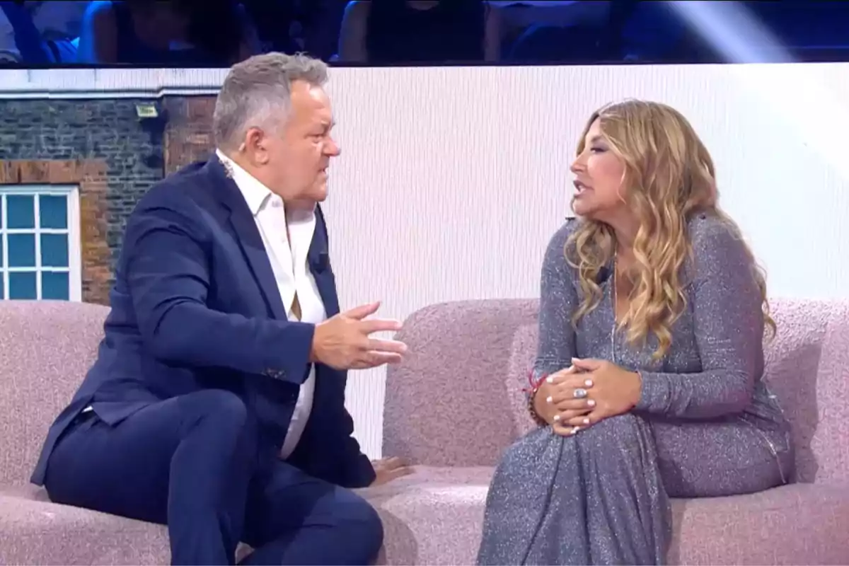 Un home i una dona asseguts en un sofà conversen de manera seriosa en un plató de televisió. Un home i una dona asseguts en un sofà conversen de manera seriosa en un plató de televisió.
