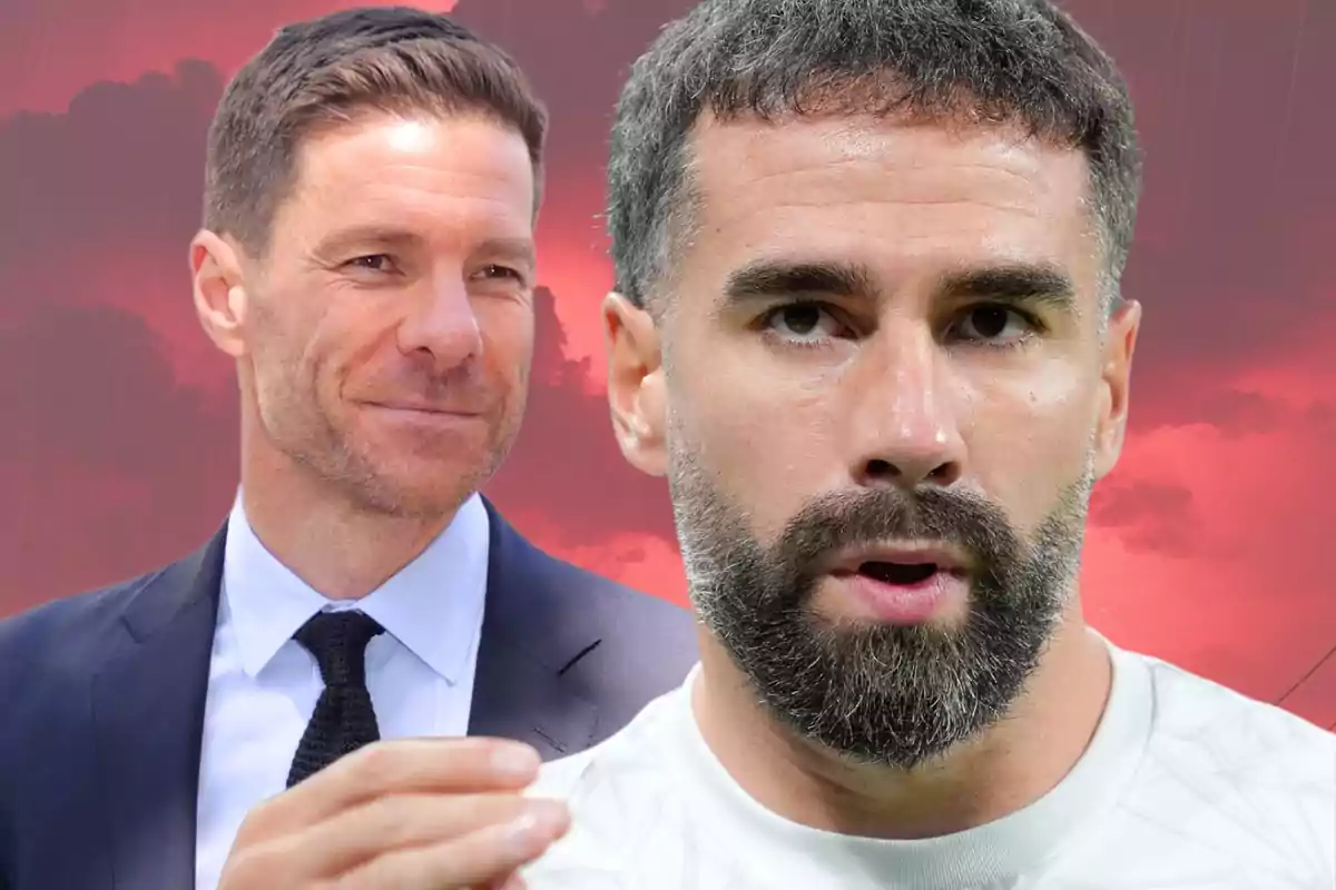 Two men in the foreground, one wearing a suit and tie and smiling, and the other with a white t-jersey and a beard with a serious expression, against a red sky background.