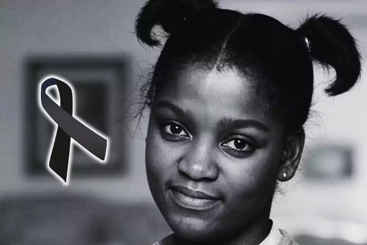 Black and white photograph of Danielle Spencer with two pigtails and a serene expression, accompanied by a black ribbon as a sign of mourning.