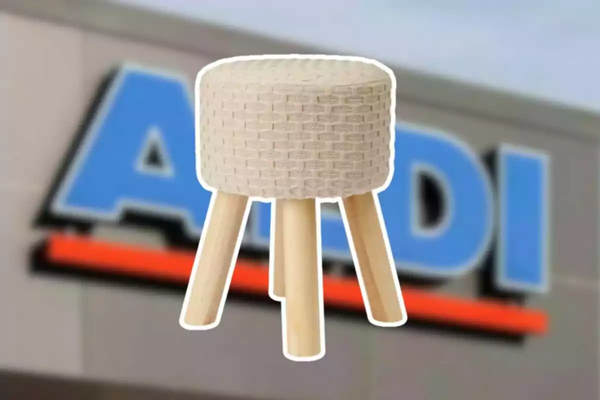 Small wooden stool with a beige upholstered seat in front of a blurry Aldi store sign Small wooden stool with a beige upholstered seat in front of a blurry Aldi store sign