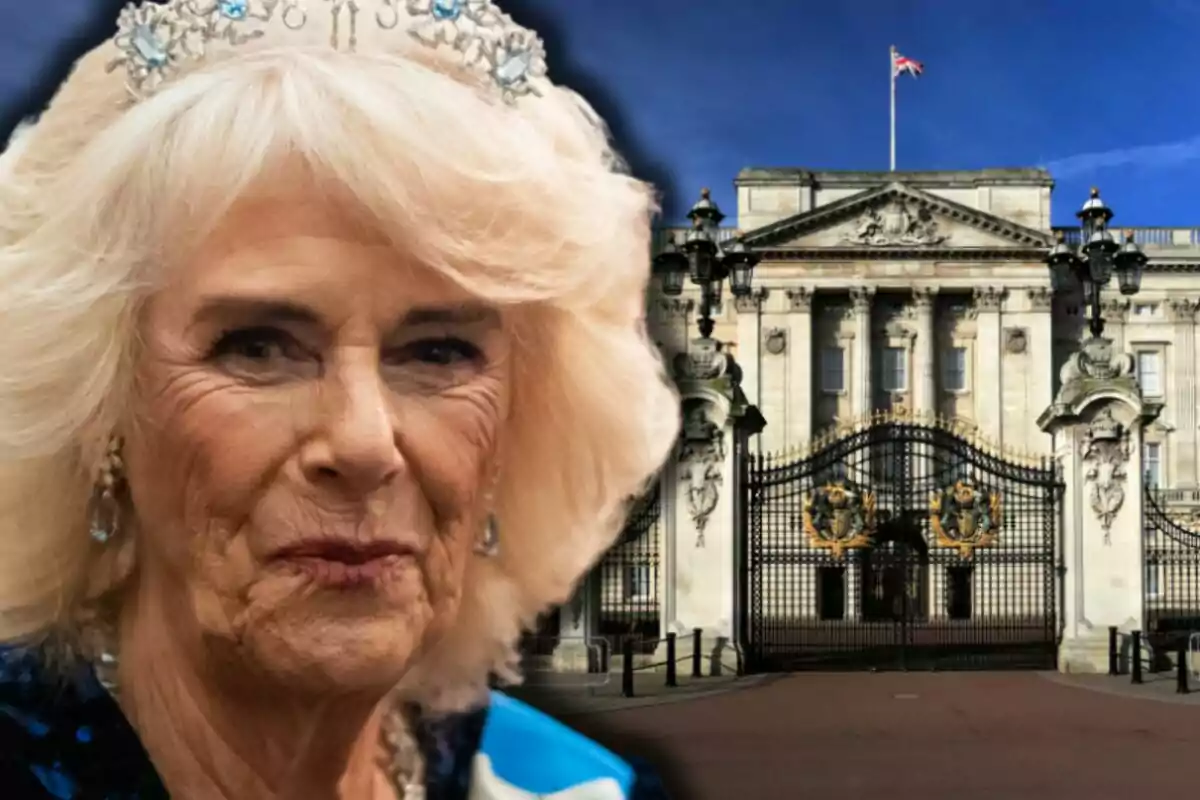 Queen Camilla with a crown and a serious expression in front of a palace with gates and a waving British flag