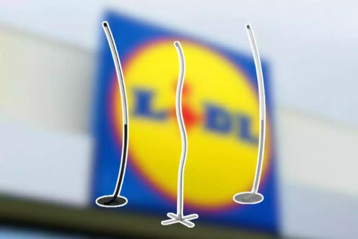 Tres penjadors corbats en primer pla amb un rètol borros de Lidl al fons Tres penjadors corbats en primer pla amb un rètol borros de Lidl al fons