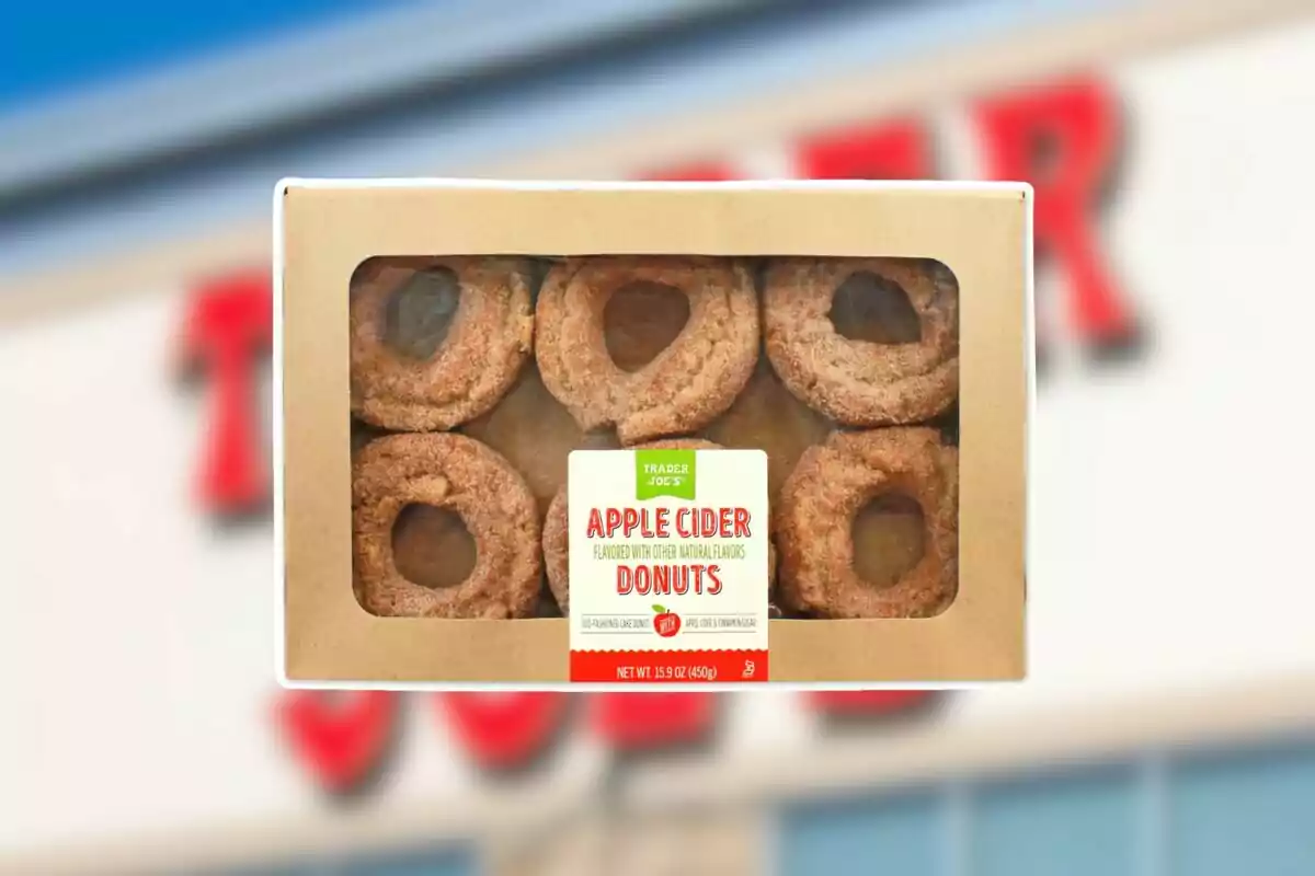 Trader Joe’s apple cider donut box with six pieces visible through a clear window Trader Joe’s apple cider donut box with six pieces visible through a clear window