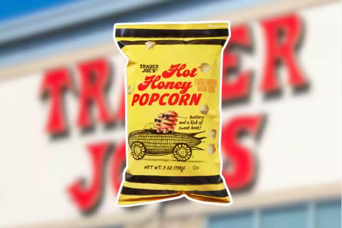 Yellow bag of Hot Honey Popcorn from Trader Joe’s with an illustration of pancakes in a car in front of a blurry store sign Yellow bag of Hot Honey Popcorn from Trader Joe’s with an illustration of pancakes in a car in front of a blurry store sign