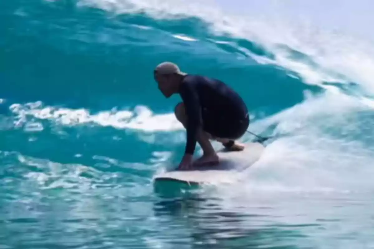 Prince Harry surfing a big wave in the sea wearing a cap and a dark suit Prince Harry surfing a big wave in the sea wearing a cap and a dark suit