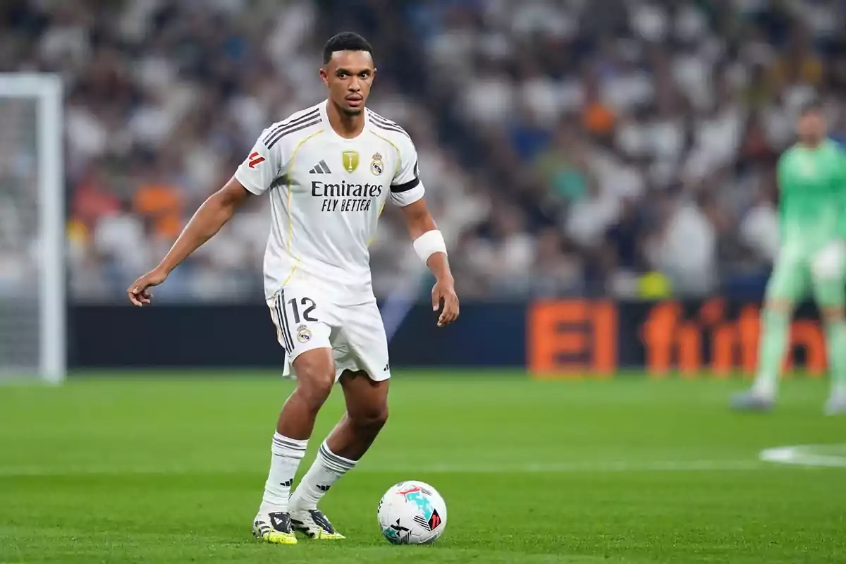 Futbolista del Real Madrid controlando el balón durante un partido en un estadio lleno de aficionados