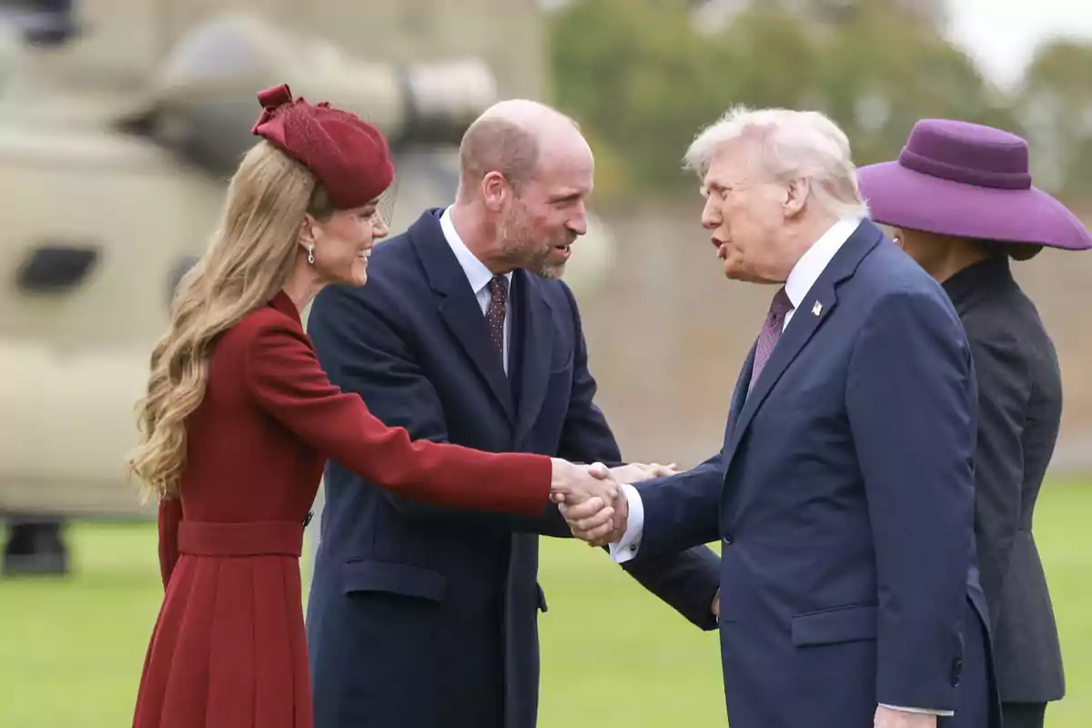 Els prínceps d'Anglaterra i Donald Trump es saluden a l’aire lliure mentre Kate amb barret vermell somriu i dona la mà a Trump. Els prínceps d'Anglaterra i Donald Trump es saluden a l’aire lliure mentre Kate amb barret vermell somriu i dona la mà a Trump.